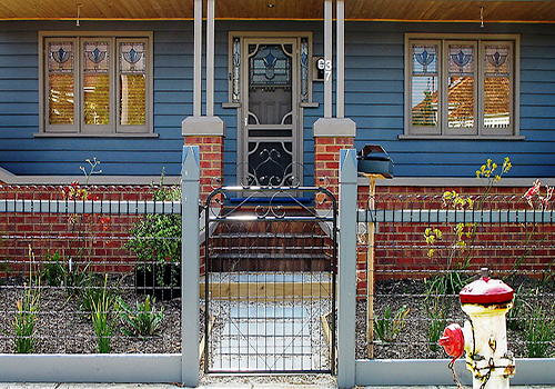 Black woven wire fence with Gardenvale gate and gothic wooden posts